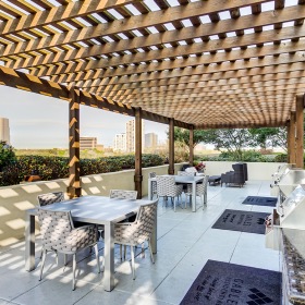 Outdoor wooden pavilion with grills and tables with chairs Outdoor wooden pavilion with grills and tables with chairs